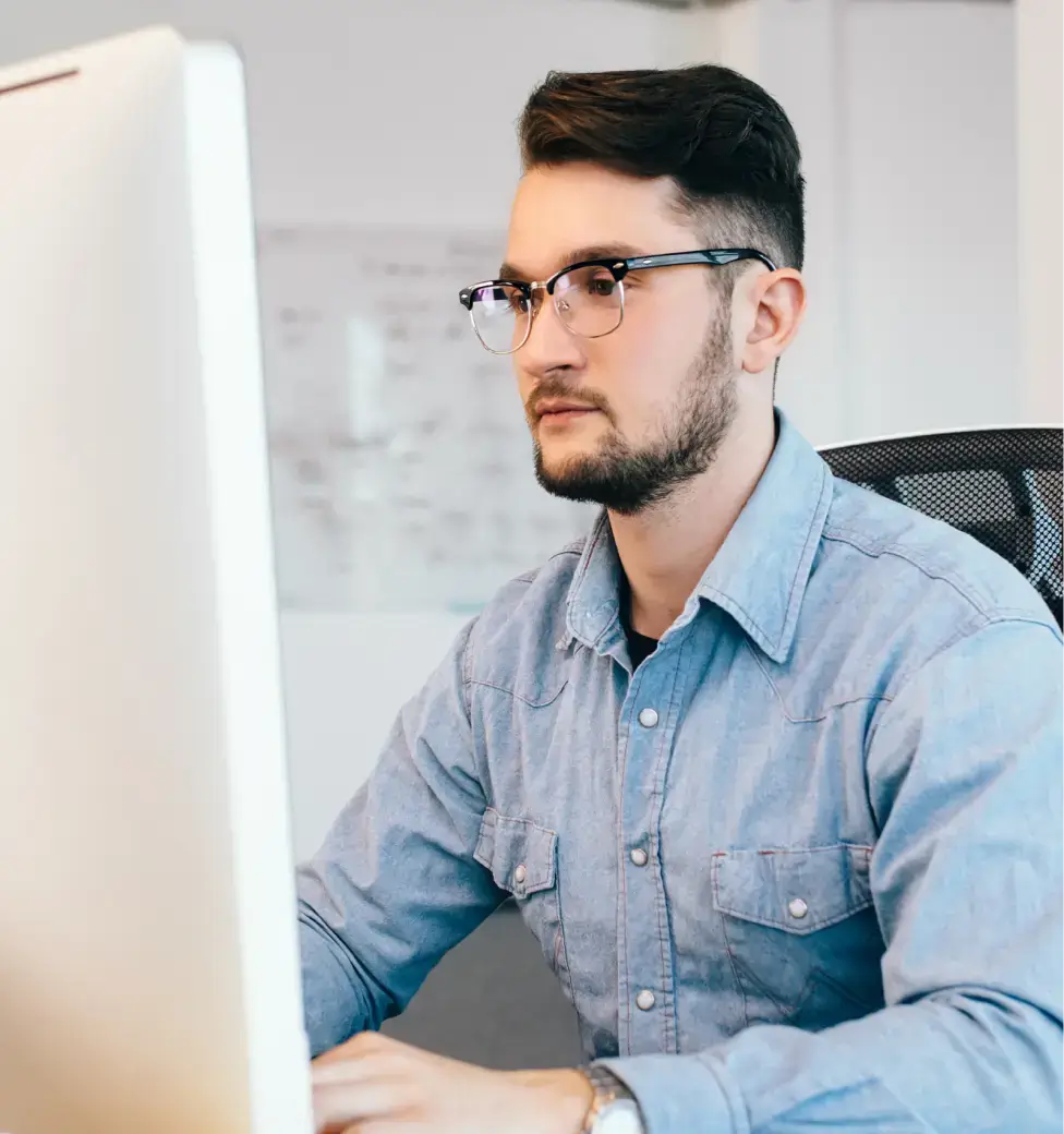 Person working at a computer desk.