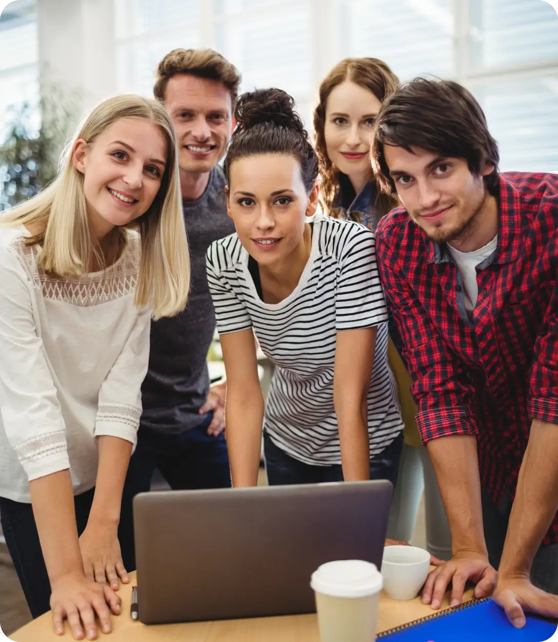 Group collaborating around a laptop.